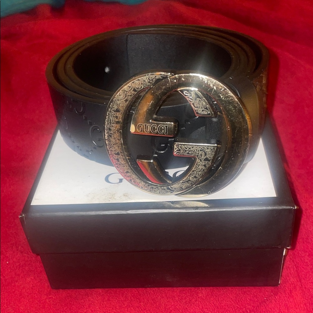 Gucci Black Leather Belt with Intricate Silver Buckle